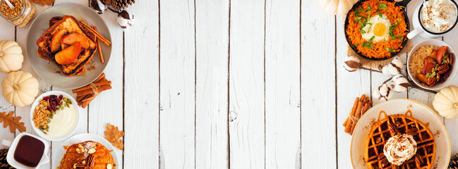 Fall breakfast or brunch buffet double border against a white wood banner background. Pumpkin spice waffles, pancakes, apple french toast, oatmeal, egg skillet, yogurt. Top view with copy space.