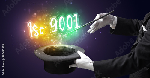 Magician hand conjure with wand and Iso 9001 inscription, shopping concept