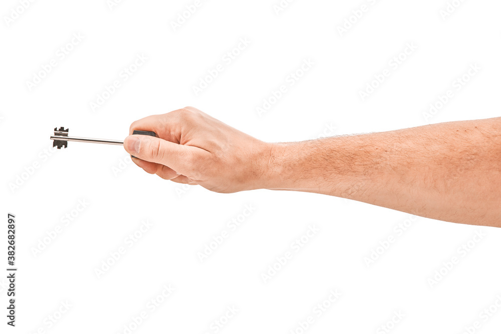 Male hand holding a key to the house, isolated over a white background. Male hand holding a key to the house, isolated over a white background.