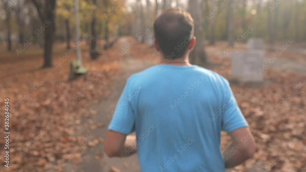 Man jogging and exercising in the park. Slow motion video.
Man jogging and exercising in the park. Slow motion video.