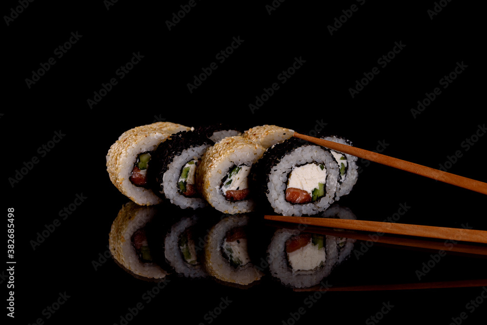 Fresh delicious beautiful sushi rolls on a dark background Fresh delicious beautiful sushi rolls on a dark background