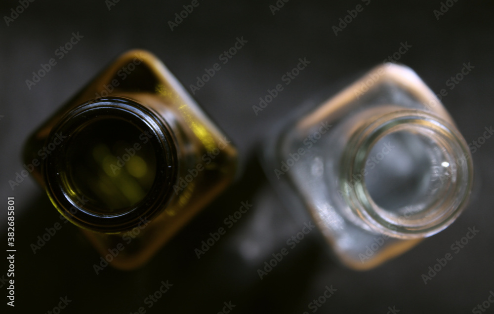 two glass bottles of different colors shot from above two glass bottles of different colors shot from above