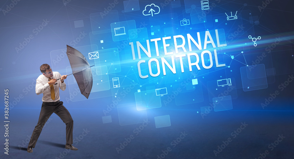 Businessman defending with umbrella from cyber attack and INTERNAL CONTROL inscription, online security concept Businessman defending with umbrella from cyber attack and INTERNAL CONTROL inscription, online security concept