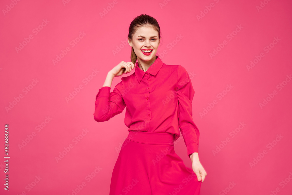 Portrait of a red-haired woman in bright clothes on a pink background cropped view of gesturing with her hands Portrait of a red-haired woman in bright clothes on a pink background cropped view of gesturing with her hands