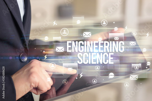 Close-up of a tablet searching ENGINEERING SCIENCE inscription, modern technology concept