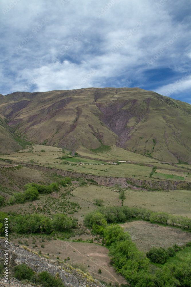 The green valley and hills under a blue sky. View of the popular landmark Bishop's slope in Salta, Argentina.