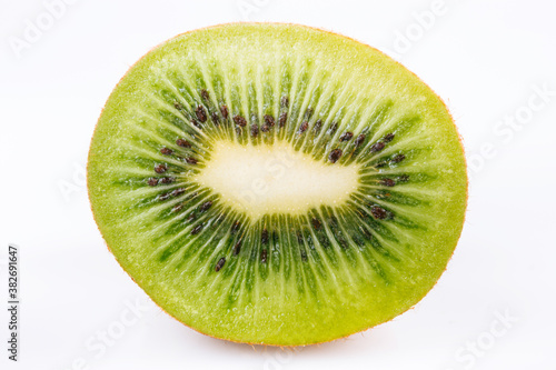Slice of kiwi on bright background
