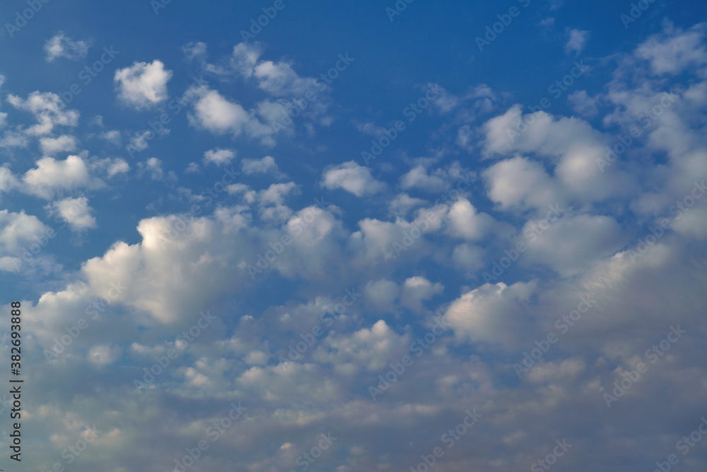 White cumulus clouds against a bright blue summer sky. White cumulus clouds against a bright blue summer sky.