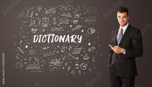 Businessman thinking with DICTIONARY inscription, business education concept
