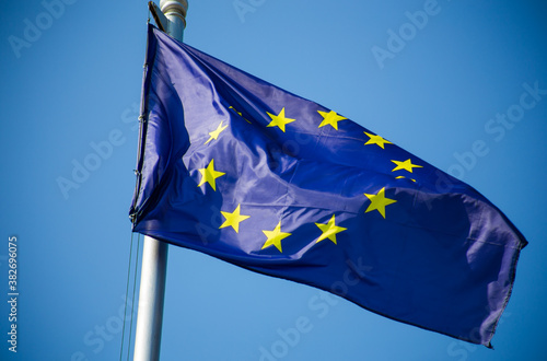 European union flag and ukrainian flag fluttering against blue sky background