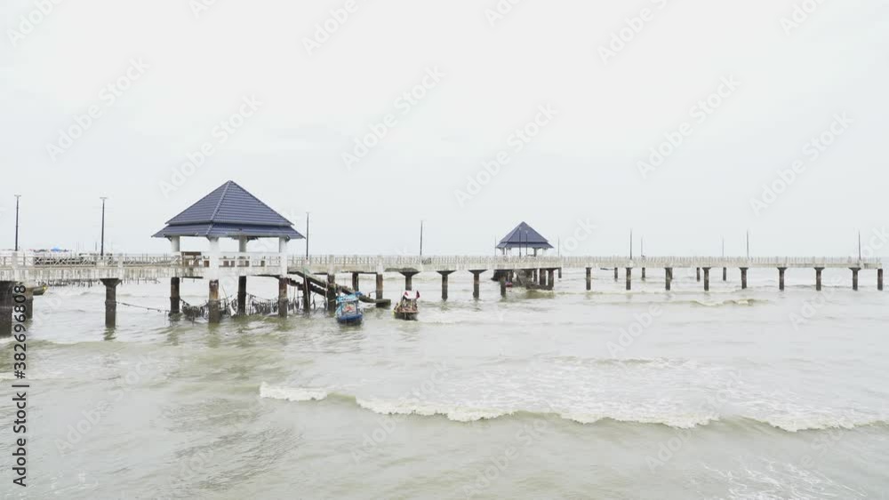 landscape of the sea, pier and longtail boat on the rainy day landscape of the sea, pier and longtail boat on the rainy day