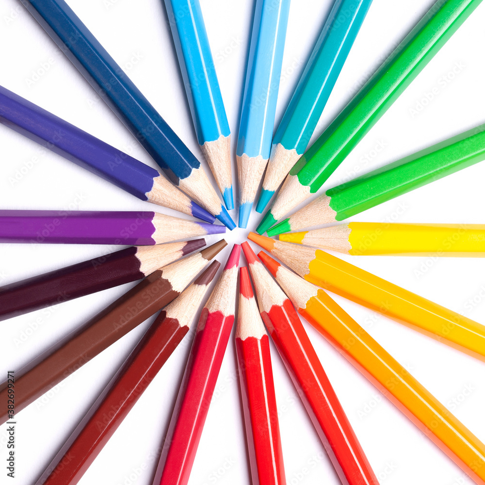 sharpened colored pencils lie in a circle with their noses in the center, school supplies, LGBT symbol, close up.