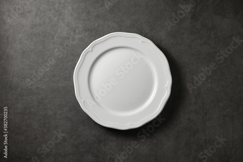 beautiful vintage plate on a dark gray concrete background, top view