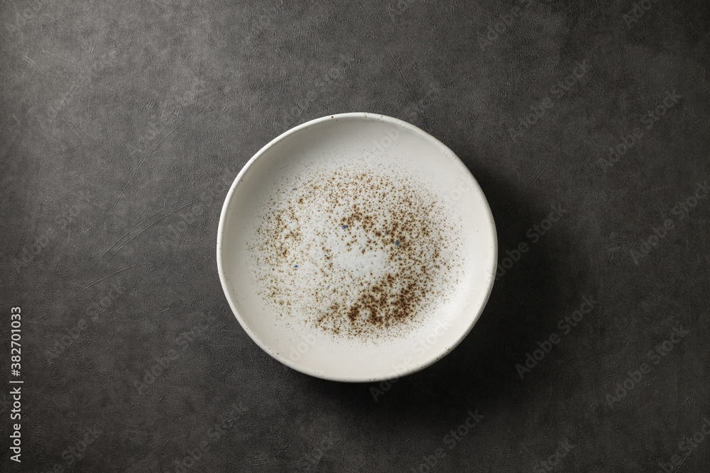 beautiful modern plate on a dark gray concrete background, top view beautiful modern plate on a dark gray concrete background, top view