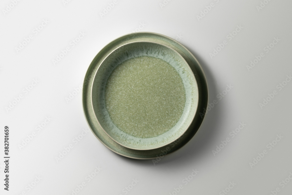 two beautiful green plates on a white background, top view
two beautiful green plates on a white background, top view