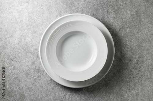 two beautiful white plates on a gray concrete background  top view 