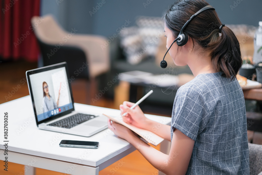 Asian attractive student girl happy at home studying online internet ...