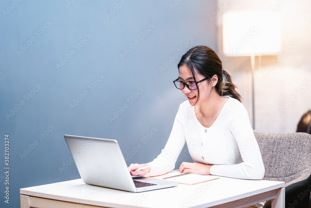 Asian businesswoman work from home using laptop computer technology small business owner freelance innovative skill independent planning thinking ideas working late at night in house living room Asian businesswoman work from home using laptop computer technology small business owner freelance innovative skill independent planning thinking ideas working late at night in house living room