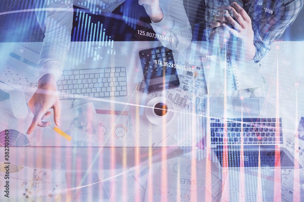 Double exposure of man and woman working together and financial graph hologram drawing. market analysis concept. Computer background. Top View. Double exposure of man and woman working together and financial graph hologram drawing. market analysis concept. Computer background. Top View.