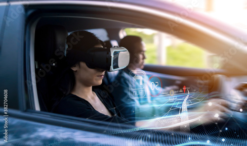 Virtual augmented reality driving user interface simulation projection holographical display screen navigation, woman driving car wearing vr headset using interface finding location travel destination