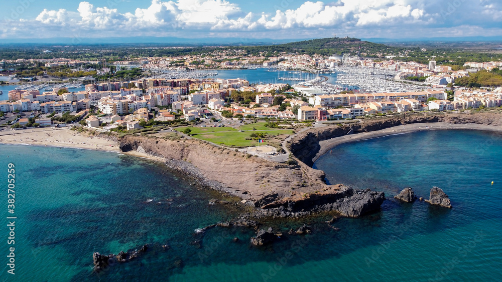 Aerial view of the Cap d'Agde sea resort on the South of France along the Mediterranean Sea - Rocky cape from above