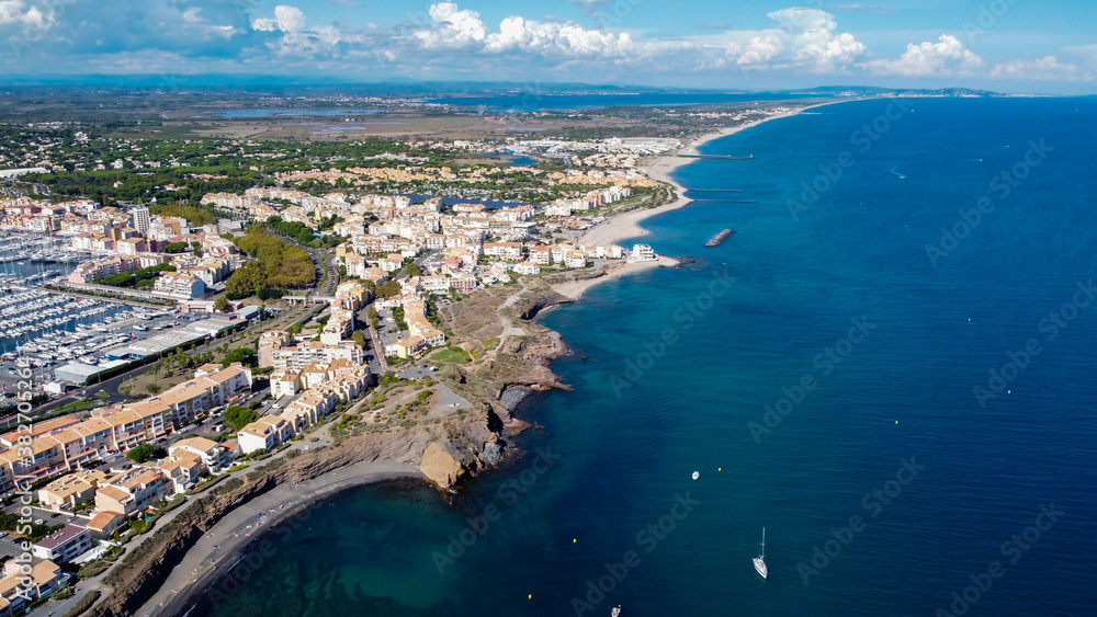 Aerial view of the Cap d'Agde sea resort on the South of France along the Mediterranean Sea - Coastline looking east