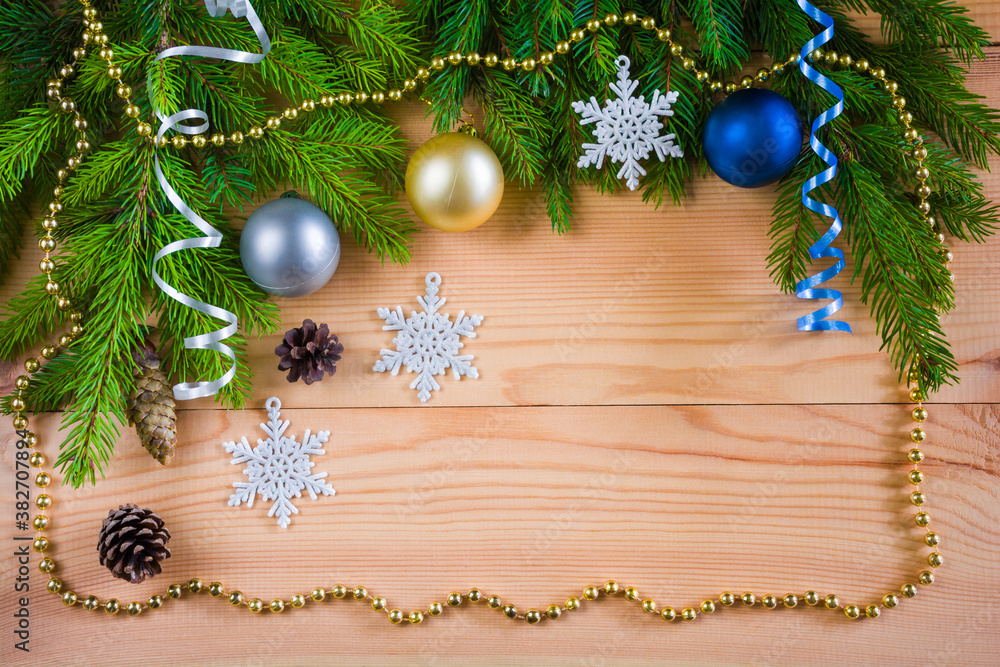 Wooden Christmas background with fir branches, Christmas balls, garlands and decorations Wooden Christmas background with fir branches, Christmas balls, garlands and decorations