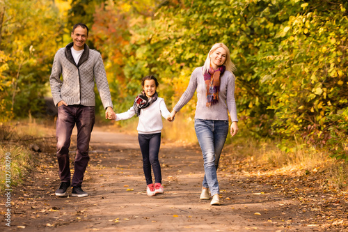 happy family walking in the autumn park