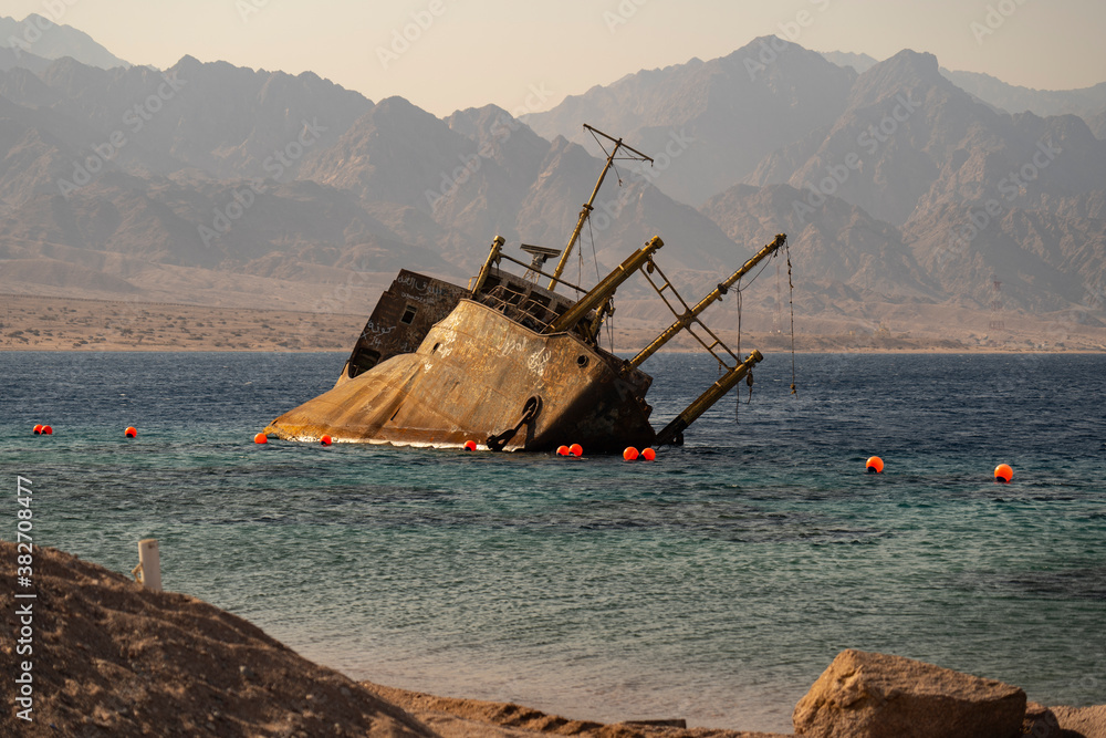 Sunset view of shipwreck in the Gulf of Aqaba off the Saudi Arabian coast, Haql Province Sunset view of shipwreck in the Gulf of Aqaba off the Saudi Arabian coast, Haql Province