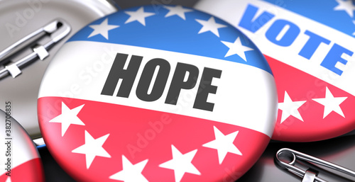 Hope and elections in the USA, pictured as pin-back buttons with American flag colors, words Hope and vote, to symbolize that t can be a part of election or can influence voting, 3d illustration photo