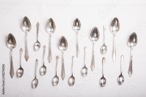 silver spoons on a white tablecloth, tablespoons and teaspoons © Stockhausen