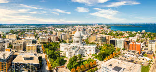 Wisconsin State Capitol and Madison skyline panorama. The Wisconsin State Capitol, houses both chambers of the Wisconsin legislature, Supreme Court and the Office of the Governor. photo
