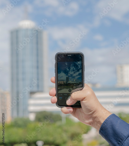 detail of male hand taking a panorama photo with the smart phone