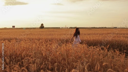 Wallpaper Mural Smiling good-looking happy young woman in a sundress spinning around in the field. Happiness concept Torontodigital.ca