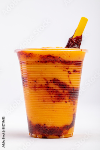 Chamoyada is a smoothie made of mango, chamoy, sugar and ice dressed with a tamarind and chile lollipop.