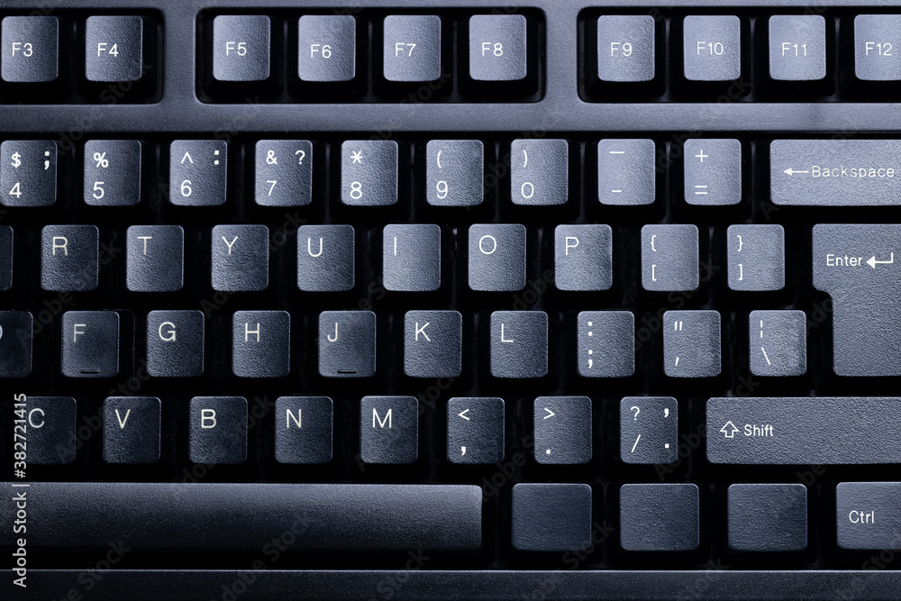 black gloomy desktop keyboard background. online business conceptual backdrop. above view