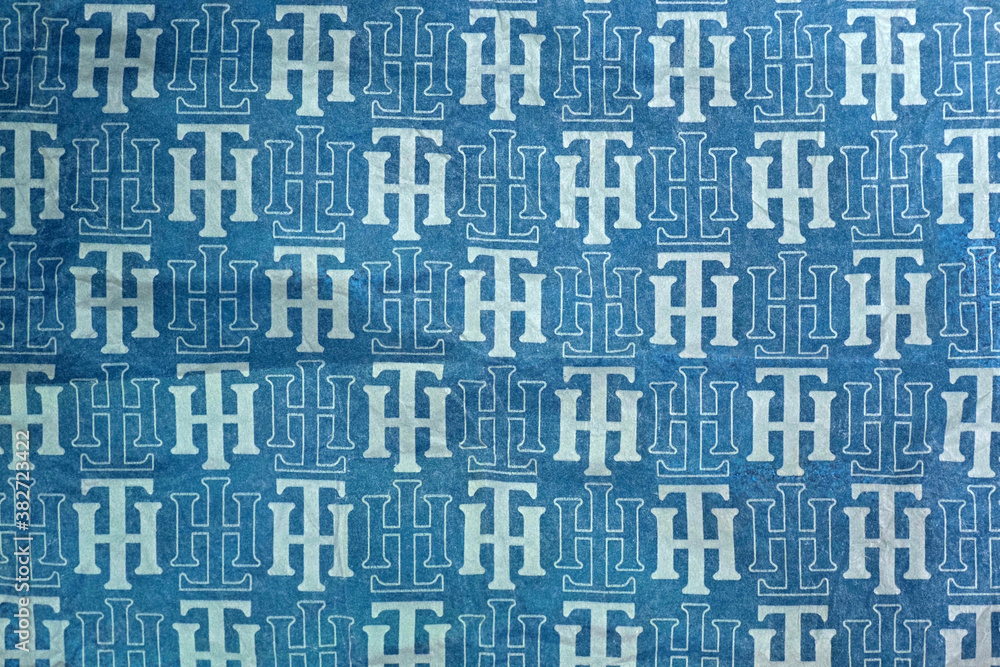 - September, 2020: Tommy Hilfiger sign. Tommy Hilfiger wrapping paper background, blue Stock Photo | Stock