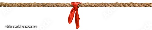 Long tug of war rope pulled tight, with red ribbon tie. Concept of conflict, competition, or rivalry. Isolated on white.