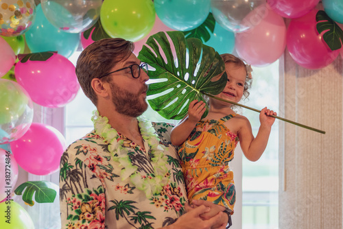 Daddy and daughter at a tropical theme birthday party at home
