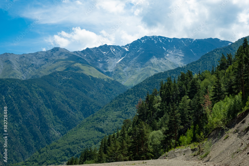 Beautiful mountain landscape with pine trees and mountain tops on a Sunny summer day, Dagestan Russia