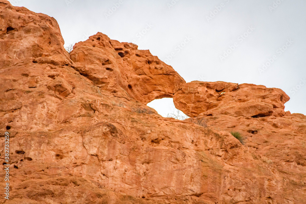 red rock formation with hole