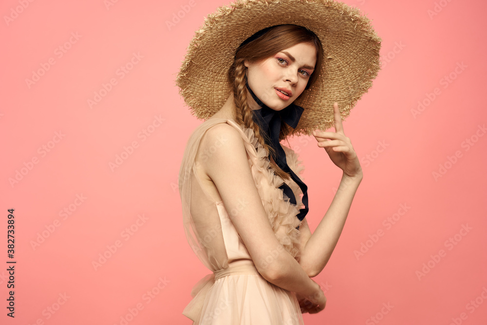 Romantic girl with pigtails and in a straw hat smile romance pink background Copy Space Romantic girl with pigtails and in a straw hat smile romance pink background Copy Space
