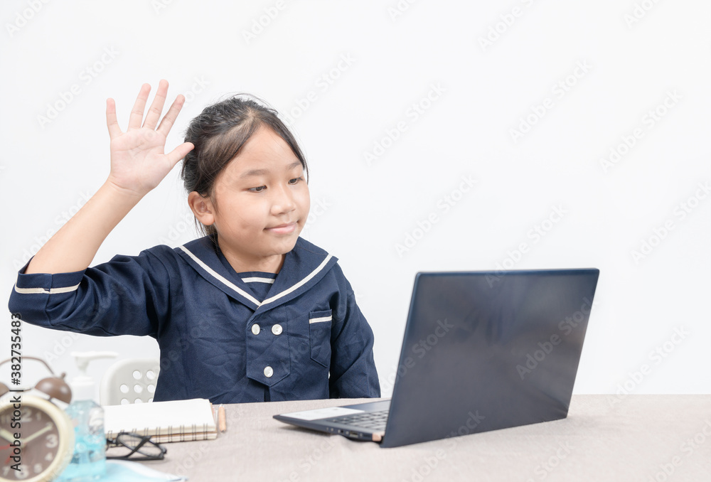 Asian girl making facetime video calling with laptop at home on white background.New normal.Covid-19 coronavirus. Social distancing.stay home Asian girl making facetime video calling with laptop at home on white background.New normal.Covid-19 coronavirus. Social distancing.stay home