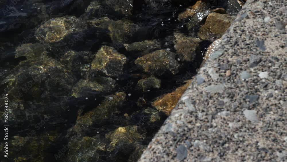 Close-up, slow motion, gentle waves crashing on rocks, Vancouver, Canada Close-up, slow motion, gentle waves crashing on rocks, Vancouver, Canada