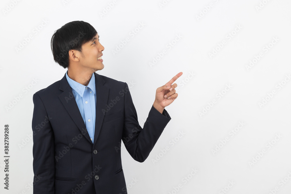 Young handsome asian business man pointing to the side with hand to present product isolated on white background. Young handsome asian business man pointing to the side with hand to present product isolated on white background.