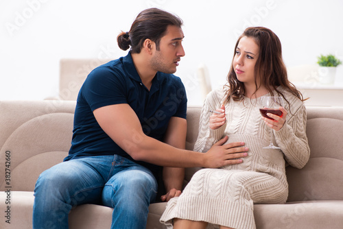 Man and pregnant woman in harmful habits concept