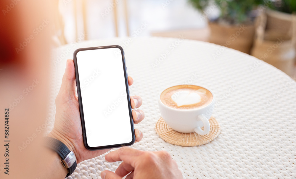 cell phone mockup blank white screen.man hand holding texting using mobile on desk at coffee shop.background empty space for advertise.work people contact marketing business,technology . cell phone mockup blank white screen.man hand holding texting using mobile on desk at coffee shop.background empty space for advertise.work people contact marketing business,technology .