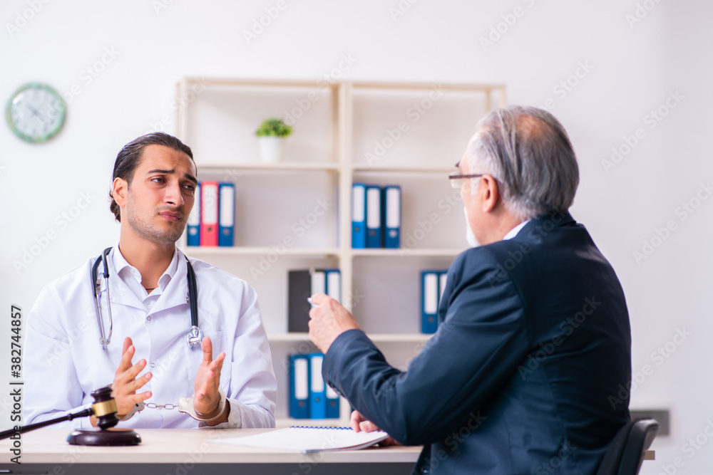 Male doctor in courthouse meeting with lawyer Male doctor in courthouse meeting with lawyer