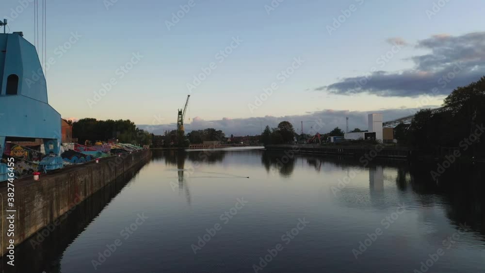 Aerial, pov, a canal in an industrial district at dawn, Gent, Belgium Aerial, pov, a canal in an industrial district at dawn, Gent, Belgium