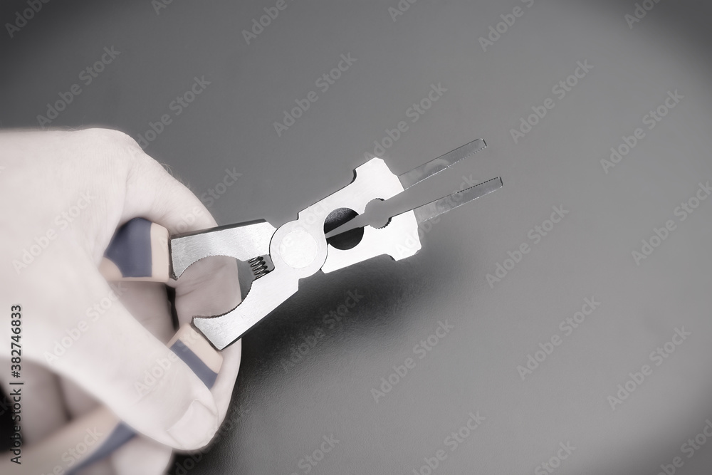 Obraz premium Hand holds a multifunction pliers